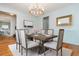 Elegant dining room with wood table, upholstered chairs, chandelier, and serene wall color at 6795 Brandon Mill Rd, Atlanta, GA 30328