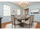 Bright dining room with table, chairs, chandelier, and natural light from the windows at 6795 Brandon Mill Rd, Atlanta, GA 30328