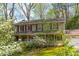 Charming two-story home with a welcoming front porch and well-manicured lawn and landscaping at 6795 Brandon Mill Rd, Atlanta, GA 30328