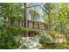 Charming two-story home with mature trees, lush landscaping and front porch at 6795 Brandon Mill Rd, Atlanta, GA 30328