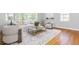 Inviting living room with hardwood floors, area rug, and abundant natural light at 6795 Brandon Mill Rd, Atlanta, GA 30328