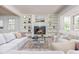 Bright living room with a fireplace, built-in bookshelves, neutral color palette, and an area rug at 6795 Brandon Mill Rd, Atlanta, GA 30328
