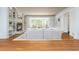 Spacious open-concept living room with fireplace, built-ins, hardwood floors, and modern furnishings at 6795 Brandon Mill Rd, Atlanta, GA 30328