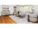 Comfortable living room with hardwood floors, a patterned rug, and abundant natural light at 6795 Brandon Mill Rd, Atlanta, GA 30328