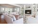 Bright living room with a fireplace, built-in bookshelves, hardwood floors, and large windows at 6795 Brandon Mill Rd, Atlanta, GA 30328