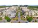 Aerial view of a bustling urban neighborhood with diverse architecture, shops, and tree-lined streets, creating a lively atmosphere at 8675 Hope Vine, Roswell, GA 30076
