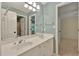 Bathroom with double sinks, white cabinets, blue walls and vanity lighting at 8675 Hope Vine, Roswell, GA 30076
