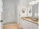 Elegant bathroom featuring a glass-enclosed shower and granite countertop vanity with decorative mirror and lighting at 8675 Hope Vine, Roswell, GA 30076