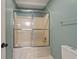 Bathroom with sliding glass shower doors and white fixtures at 8675 Hope Vine, Roswell, GA 30076
