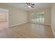 Bedroom featuring neutral walls, wood floors, white trim, and a large window with lots of natural light at 8675 Hope Vine, Roswell, GA 30076