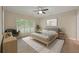 Calm bedroom with neutral tones, fan, stylish rug, and shuttered windows at 8675 Hope Vine, Roswell, GA 30076