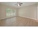 Bedroom featuring neutral walls, wood floors, white trim, and a large window with lots of natural light at 8675 Hope Vine, Roswell, GA 30076