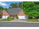 Charming single-story brick home features an attached two-car garage and manicured front lawn at 8675 Hope Vine, Roswell, GA 30076