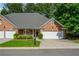 Charming single-story brick home features an attached two-car garage and manicured front lawn at 8675 Hope Vine, Roswell, GA 30076