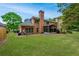 Beautiful brick home with large backyard, screened-in porch, and manicured lawn at 8675 Hope Vine, Roswell, GA 30076