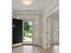 Welcoming foyer with a black front door and views of the landscaped yard at 8675 Hope Vine, Roswell, GA 30076