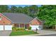 Charming brick home with a well-manicured lawn, two-car garage, and covered front porch at 8675 Hope Vine, Roswell, GA 30076