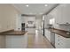 Spacious kitchen with white cabinets, stainless appliances, and granite countertops at 8675 Hope Vine, Roswell, GA 30076
