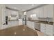 Spacious kitchen featuring white cabinets, stainless steel appliances, and a large island at 8675 Hope Vine, Roswell, GA 30076