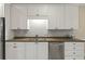 Well-lit kitchen with stainless steel appliances and elegant countertops at 8675 Hope Vine, Roswell, GA 30076