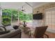 Relaxing screened patio with ceiling fan, brick accent wall, and views of the backyard at 8675 Hope Vine, Roswell, GA 30076
