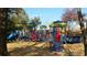 Community playground with colorful equipment, ramps, and seating area at 8675 Hope Vine, Roswell, GA 30076