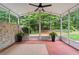 Bright sunroom with brick accent wall, ceiling fan, and views of the lush, green backyard at 8675 Hope Vine, Roswell, GA 30076