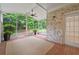 Screened-in sunroom with brick floor and exposed brick accent wall at 8675 Hope Vine, Roswell, GA 30076