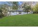 Backyard featuring a single-story home, lush lawn, and trees with a rear door and small patio at 2378 Green Forrest Dr, Decatur, GA 30032