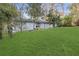 View of backyard with a single-story house, lush lawn, and trees, and a rear door entrance at 2378 Green Forrest Dr, Decatur, GA 30032