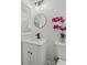 This bathroom features a white vanity, round mirror, and a flower pot for a relaxing and serene atmosphere at 2378 Green Forrest Dr, Decatur, GA 30032