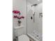 Modern bathroom features a pebble-stone shower floor, sleek shower hardware, and a decorative orchid on the toilet at 2378 Green Forrest Dr, Decatur, GA 30032