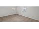 A cozy bedroom features neutral carpet, two windows letting in natural light, and a warm, inviting atmosphere at 2378 Green Forrest Dr, Decatur, GA 30032