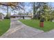 A well-maintained home featuring a long driveway, expansive lawn, and mature trees at 2378 Green Forrest Dr, Decatur, GA 30032