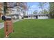 Charming ranch-style home with freshly painted exterior and expansive green lawn and an adjacent house sharing the driveway at 2378 Green Forrest Dr, Decatur, GA 30032