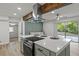 Open kitchen and living area featuring a large island and modern appliances with backyard views at 2378 Green Forrest Dr, Decatur, GA 30032