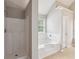 Bright bathroom featuring a walk-in shower and soaking tub with natural light at 2896 Chilhowee Dr, Atlanta, GA 30331