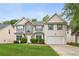 Two-story home featuring a stone facade, well-manicured lawn, and an attached two-car garage, on a sunny day at 2896 Chilhowee Dr, Atlanta, GA 30331