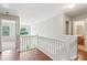 Hallway with hardwood floors, a staircase, and access to a well-lit bathroom at 2896 Chilhowee Dr, Atlanta, GA 30331