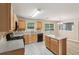 Spacious kitchen featuring wood cabinets, modern appliances, with view into dining area at 2896 Chilhowee Dr, Atlanta, GA 30331