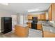Open kitchen featuring wood cabinets, black appliances, and an island with gray countertop at 2896 Chilhowee Dr, Atlanta, GA 30331