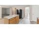 Kitchen island with gray countertops, adjacent to black refrigerator and view into living area at 2896 Chilhowee Dr, Atlanta, GA 30331