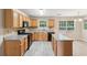 Well-lit kitchen featuring wood cabinets, modern appliances, and an island with gray countertops at 2896 Chilhowee Dr, Atlanta, GA 30331