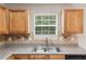 Close-up on the kitchen sink area with window view and tan backsplash at 2896 Chilhowee Dr, Atlanta, GA 30331