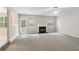 Bright living room featuring a fireplace, neutral carpeting, and view of the backyard through a glass door at 2896 Chilhowee Dr, Atlanta, GA 30331