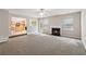 Living room with a fireplace, neutral carpeting, and open to the kitchen and backyard through glass door and window at 2896 Chilhowee Dr, Atlanta, GA 30331