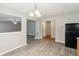 Open living room with hardwood style flooring, black refrigerator, and dining view at 2896 Chilhowee Dr, Atlanta, GA 30331