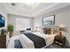 Bedroom featuring a decorative tray ceiling, neutral colors, and a bright window at 2896 Chilhowee Dr, Atlanta, GA 30331