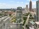 Stunning aerial view of a modern glass-exterior skyscraper with a rooftop pool deck and city skyline at 45 Ivan Allen Jr Nw Blvd # 2705, Atlanta, GA 30308