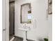 Modern bathroom with pedestal sink, walk-in shower, and decorative mirror at 45 Ivan Allen Jr Nw Blvd # 2705, Atlanta, GA 30308